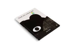 A hardcover book titled Sind wir schon da? by Sven Völker, lying at an angle on a white surface. The cover has a minimalist design with a large, abstract black shape of an animal's head with one large white circular eye. A small yellow and blue butterfly rests on the top of the head.