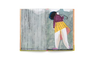 An open book with a colorful, stylized illustration across two pages. On the right, a person with dark curly hair, wearing a purple jacket and yellow skirt, walks while holding a closed blue umbrella and looking up. The left page depicts falling rain with vertical lines of black dots against a muted background.