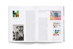 An overhead shot of an open art book with a two-page spread about Henri Matisse. The pages, written in German, show a black-and-white photo of Matisse in his studio, a color block grid, a colorful painting of an interior, and two photos of the artist's paint palettes.