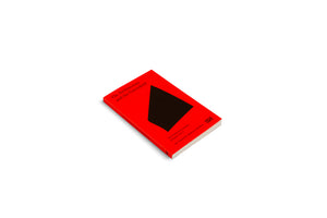 A bright red book titled On Architecture and the Greenfield lies on a white surface, angled to show the cover and spine. The cover features a large black abstract quadrilateral shape and additional text identifying it as The Political Economy of Space Vol. 2, edited by Charlotte Malterre-Barthes and published by Hatje Cantz.