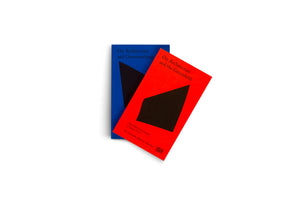 A top-down photo of two minimalist paperback books on a white background. A bright red book titled On Architecture and the Greenfield rests diagonally on a blue book titled On Architecture and Greenwashing. Both covers feature a large, black abstract shape.