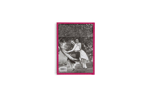 The back cover of a book with a bright pink border, set against a plain white background. The cover features a black-and-white photograph of two smiling women sitting together on a thick tree branch. A block of German text is printed above the image, and a barcode is at the bottom.