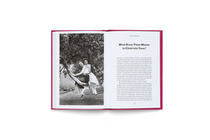 An open book with a vibrant magenta cover lies flat on a white surface. The left page shows a vintage black-and-white photo of two women smiling while sitting on a tree branch. The right page has the title, What Drove These Women to Climb Into Trees? by Johanna Adorján, above several paragraphs of text.