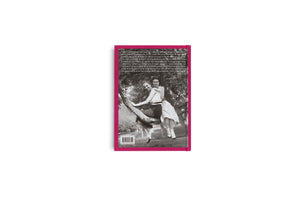 The back of a book with a magenta border, shown against a plain white background. The cover features a black-and-white photograph of two young women smiling while sitting on a tree branch. A block of text is visible above the image, and a barcode is at the bottom.