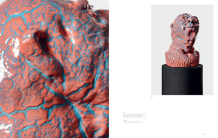A two-page art catalog spread featuring a ceramic sculpture. On the left is a macro shot of the sculpture's surface, showing a glossy, textured coral glaze with bright blue filling the deep crevices and wrinkles. On the right is a full view of the artwork: a stylized bust of a person's head and shoulders, with the same coral and blue finish, displayed on a black cylindrical pedestal against a light gray background.