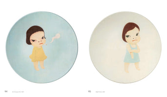A side-by-side display of two circular artworks by Yoshitomo Nara from 2001. On the left, a cartoon girl in a yellow dress smokes a cigarette against a blue background. On the right, a girl in a blue dress stands with her arms crossed against a white background. Both characters have large heads and defiant, sullen expressions.