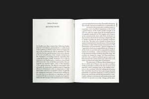 A top-down photograph of an open book laid flat on a dark surface. The book has white pages with black serif text. The left page shows the author, Mahan Moalemi, and the title, BEYOND HOPE, above the start of the text. The text continues on the right page and includes numbered citations.