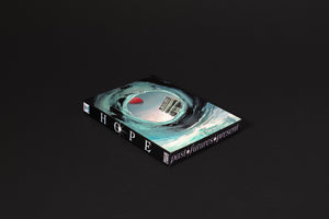 A book with a surrealist cover lies on a black surface. The cover art shows a swirling teal and black wave that forms a vortex, revealing a red sun and a tilted building inside. The spine reads HOPE and past futures present in a stylized white font.