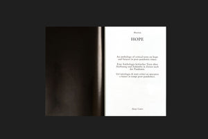 A minimalist photograph of an open book against a black background. The right-hand page is white and features the title HOPE in a serif font. Below the title, a description is written in English, German, and Italian, identifying the book as an anthology of critical texts on hope and futures in post-pandemic times. The names Museion and Hatje Cantz are also on the page.