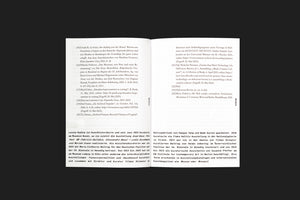 A top-down photograph of an open book laid flat on a black background. The pages contain German text, organized with numbered footnotes at the top and paragraphs of body text below. The page numbers DE023 and DE024 are visible in the outer margins.