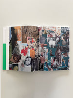 An open book lies flat on a white surface, revealing a two-page spread filled with a dense, colorful collage. The eclectic assortment of cut-out images includes an astronaut, a red map, a spotted deer, a wolf, ancient artifacts, historical portraits, and paintings, all layered together in a scrapbook style. A thick green vertical stripe is visible on the book's left edge.