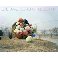 The cover of the book Chinese Fun by Stefano Cerio, featuring a giant, colorful sculpture of a walnut shell overflowing with oversized fruit. The sculpture rests on a patch of dry grass by a roadside in a bleak, winter landscape under an overcast sky.