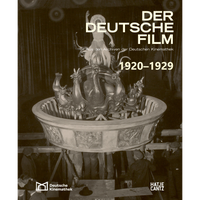 A sepia-toned behind-the-scenes photograph on the cover of the book Der Deutsche Film 1920-1929, showing crew members supporting a large, ornate prop with a costumed dancer on it.