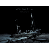 A stark, monochrome photograph of an old, derelict ship resting on a dark shore at night, with the title At The Heart Of It All by Petri Juntunen above it.