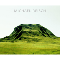 A large, lush green hill sits in a field of grass under the name Michael Reisch.