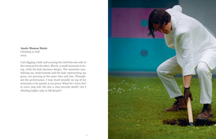 A two-page book spread. The left page features text by Anaïs-Manon Mazic for her 2023 performance, Climbing to Fall, describing the symbolism of digging a hole. The right page shows a photograph of a person in a white suit and leather gloves, using a shovel to dig in a vibrant green lawn against a pink and turquoise color-blocked wall.