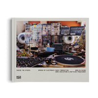 A photograph of the book titled Inside the Studio: Spaces of Electronic Music Production. The light gray cover shows a complex music studio filled with modular synthesizers, a web of colorful cables, large speakers, a mixing console, and a turntable in the foreground.