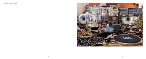 A two-page spread from a book or magazine. The left page is blank white with the name RICARDO VILLALOBOS at the top. The right page is a full-color photograph of a music studio, densely packed with electronic equipment. In the foreground is a turntable and a mixing console. The background is filled with walls of modular synthesizers, interconnected by a complex and chaotic tangle of colorful patch cables, with two large white horn speakers visible.