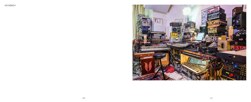 A two-page book spread. The left page is blank except for the name HAINBACH. The right page is a photograph of Hainbach's music studio, a cluttered room packed wall-to-wall with vintage synthesizers, keyboards, audio racks, and a complex web of colorful cables. A single stool sits in the center.
