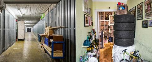 A diptych contrasting two spaces. On the left, a long, stark basement corridor is lined with metal storage units. On the right, a cluttered and personal hallway is filled with a stack of car tires, shelves of bottles, framed posters, and a doorway revealing a room packed with vinyl records.