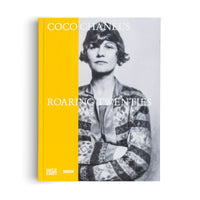 A hardcover book titled Coco Chanel's Roaring Twenties, set against a plain white background. The cover has a bright yellow spine and a matching vertical band on the left, with the title in white text. The right side features a black-and-white portrait of a young Coco Chanel with bobbed hair, wearing a patterned cardigan with her arms crossed.