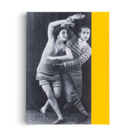 A book cover with a bright yellow spine and a black-and-white photograph of two dancers, a man and a woman, in 1920s attire. They are in a dynamic, modern dance pose against a dark background. The woman is in front, wearing a knitted tunic and a dark cap, while the man behind her wears a striped sweater.