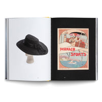 An open book with a two-page spread. On the left, a photograph of a wide-brimmed black hat with a ribbon on a mannequin head against a white background. On the right, a vintage Art Deco-style poster for Monaco Sports, featuring an illustration of a woman driving a vehicle above a coastal scene, set against a black background.