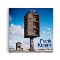 The book cover for The Best of Frank Kunert, featuring a surreal photograph of a tall, narrow, concrete hotel elevated on a single pillar. The brutalist-style building has three doors stacked vertically and the word HOTEL spelled down its side. The scene is set on a roadside next to sand dunes under a blue sky with clouds.
