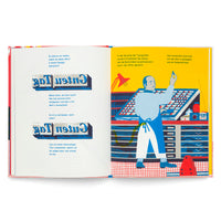 A two-page spread from a brightly illustrated book about typography. The left page shows German text and examples of mirror-image typesetting. The right page features a stylized illustration of a typesetter in a blue apron working at a type case in a workshop with red and blue patterns against a yellow background.