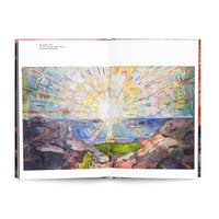A studio photograph of an open art book showing Edvard Munch's 1911 painting, The Sun. The expressionist painting is spread across two pages and depicts a vibrant, stylized sun with long, multi-colored rays of light radiating over a dark, rocky coastal landscape and the sea below.