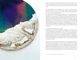 A page from an art book showing German text next to a large, circular abstract painting. The top of the painting is a smooth blend of purple, pink, and green. The bottom half is a thick, heavily-textured white and grey material that looks like cracked earth, with a jagged, decaying edge that reveals the canvas beneath.