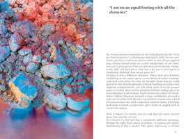 A two-page book spread. On the left is a close-up photograph of a pile of rocky, earthen material covered in vibrant blue and reddish-pink pigments that bleed onto a smooth surface at the bottom. The right page features a large quote at the top, I am on an equal footing with all the elements, followed by several paragraphs of text.