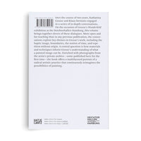 The back cover of a light gray paperback book, viewed from a slight angle against a white background. The cover features a descriptive text about artist Katharina Grosse, a barcode with an ISBN, and logos for the publisher Hatje Cantz and the exhibition hall Deichtorhallen Hamburg at the bottom.