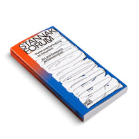 An angled view of a paperback book titled Stannaki Forum on a white background. The book cover features a vibrant orange-to-blue gradient with bold black text at the top. A large, abstract graphic made of layered, white, cut-out shapes dominates the center and bottom of the cover. The spine, also featuring the gradient and title, is visible on the left.