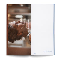 An open book viewed from above. The left page features a vertical photograph of a woman in profile, her head tilted back as she looks up. White text next to her asks, Isn't it Orientalism? The right page is mostly white, with a small caption in the bottom corner that reads, Interview with a Pistol, Natalia Zaitseva, 2023. Video still. The page number is 205.