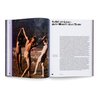 An open book with a two-page spread about Rudolf von Laban. The left page features a vintage color photograph of three nude people dancing on a rocky shore with a forested mountain in the background. The right page contains German text under the title Rudolf von Laban - Jeder Mensch ist ein Tänzer.