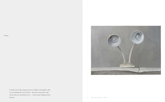A two-page spread from an art book. The left page has a heading, Plates, and a paragraph of text. The right page features a realistic painting of two white, gooseneck desk lamps on a shared base, sitting on a surface against a muted grey background.