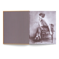 An open book showing a two-page spread. The left page features a pattern of thin, vertical white stripes on a dark background with an orange border. The right page displays a vintage, sepia-toned photograph of a woman with short, dark hair sitting on a wooden chair in profile, resting her chin on her hand in a pensive pose. She wears a striped top and wide-legged trousers.