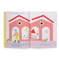 An open children's book with a colorful illustration spread across two pages. A woman with blue hair, Alma, walks her small dog, Max, on a long green leash in front of two connected red brick buildings. The buildings are the Museum of Shapes, and colorful geometric forms are visible through large arched doorways. German text captions are at the top and bottom of the pages.