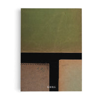 A flat lay, top-down view of several vintage notebooks against a white background. The top half of the image is a large, textured, olive-green folder. Below a black horizontal band, the corners of two smaller notebooks are visible: one is a brown, spiral-bound notebook, and the other is a tan notebook with the year 1941 handwritten on it. The white letters K.B.H.G are printed at the bottom.