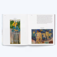 An open art book on a white surface showing two pages. The left page, 122, features a painting by Edvard Munch of a woman in a yellow hat and blue dress leaning on a fence. The right page, 123, has a block of German text above a painting by Munch depicting several nude men on a rocky shore.