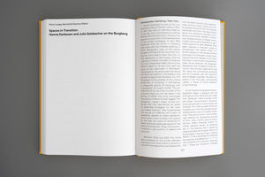 An open book with a yellow spine lies on a flat grey surface. The left page displays the title Spaces in Transition and the authors names, Petra Lange-Berndt and Dietmar Rübel. The right page shows two columns of text under the heading Introduction: Hamburg / New York.